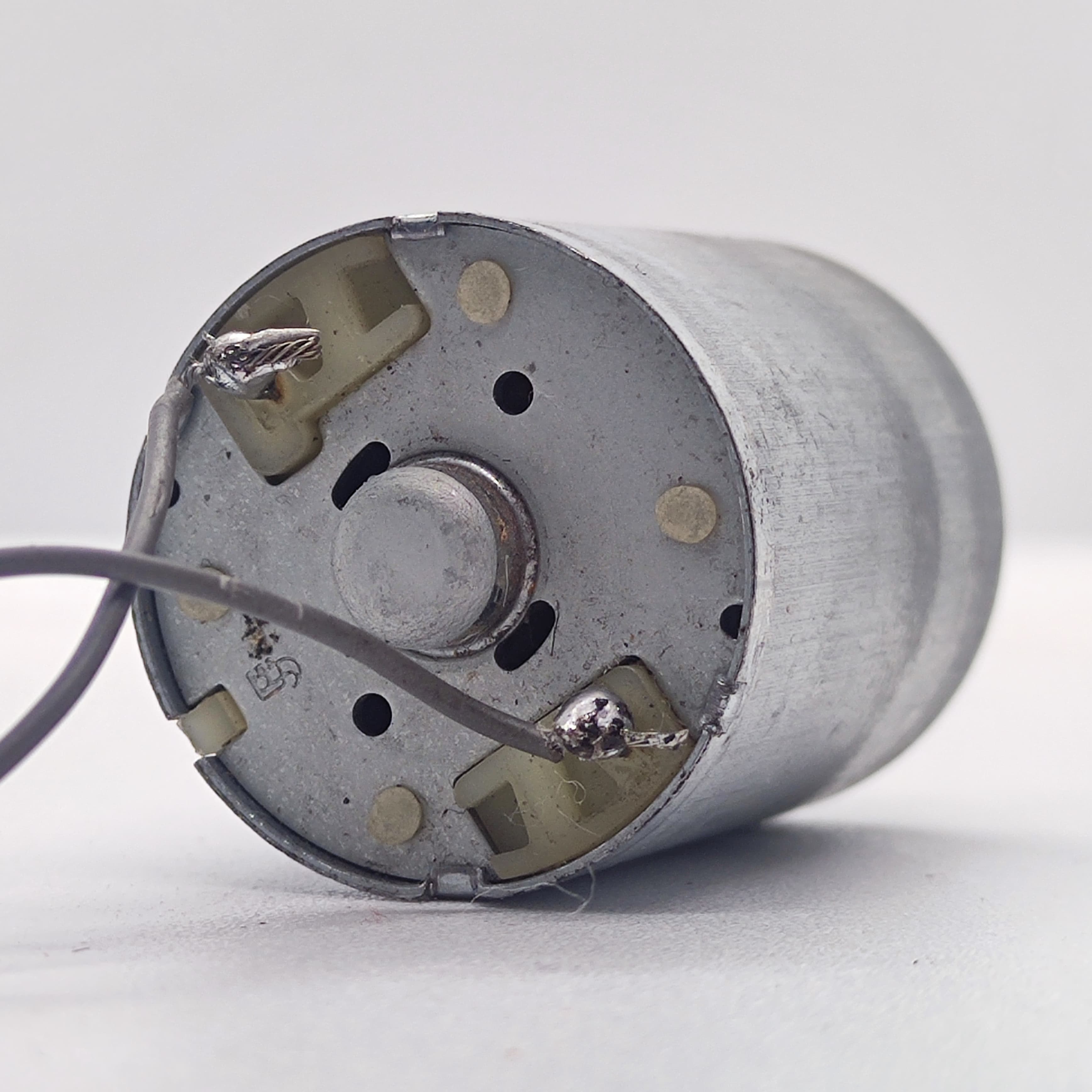 DC 2V To 24V 5100 RPM High Torque Mini Micro Motor DC Motor - a close-up of the rear end showing two soldered wire terminals on a silver cylindrical motor housing.