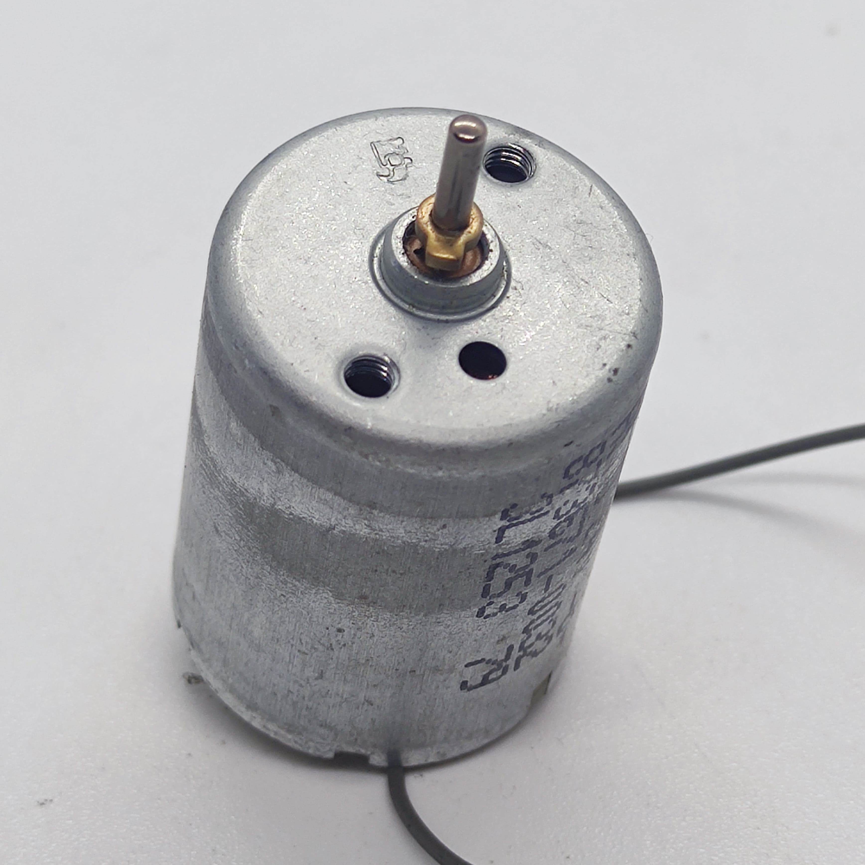 DC 2V To 24V 5100 RPM High Torque Mini Micro Motor DC Motor - a silver cylindrical motor with a metal shaft and two thin wires extending from the base.