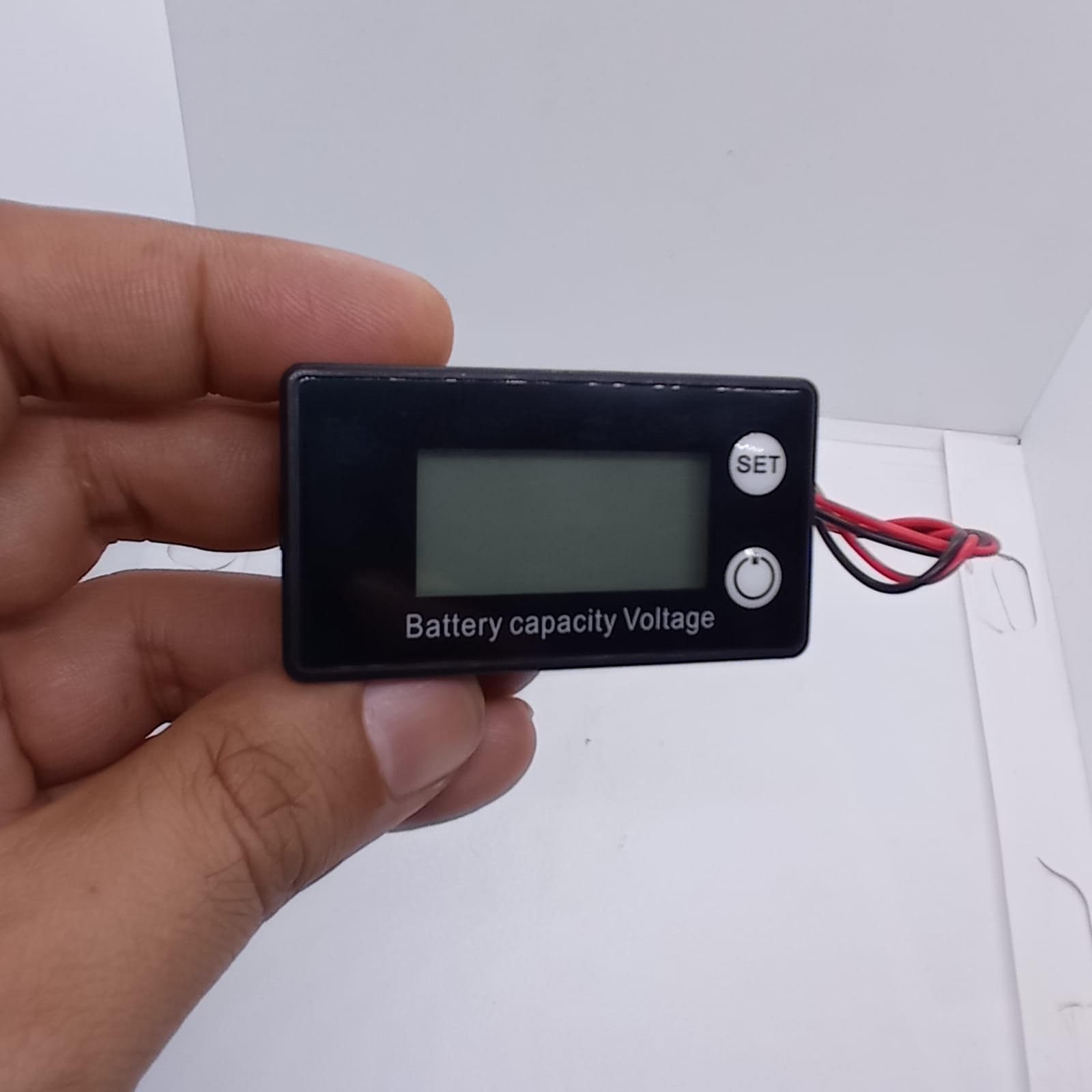 DC 8V-100V Battery Capacity Indicator Lead Acid Lithium LiFePO4 Car Motorcycle Voltmeter Voltage Gauge 12V 24V 48V 72V - a black rectangular digital gauge held in a hand, featuring a blank screen, a SET button, and a power button.