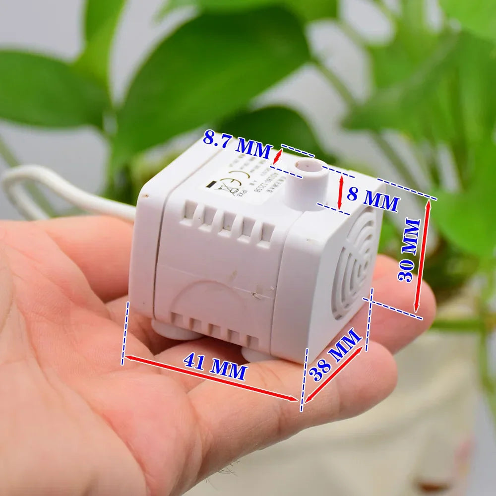 DC Brushless Water Pump DC 12V 2W Submersible Pump Fish Tank Rockery Circulation - a small white submersible pump held in a hand with blue dimension labels indicating its size in millimeters.