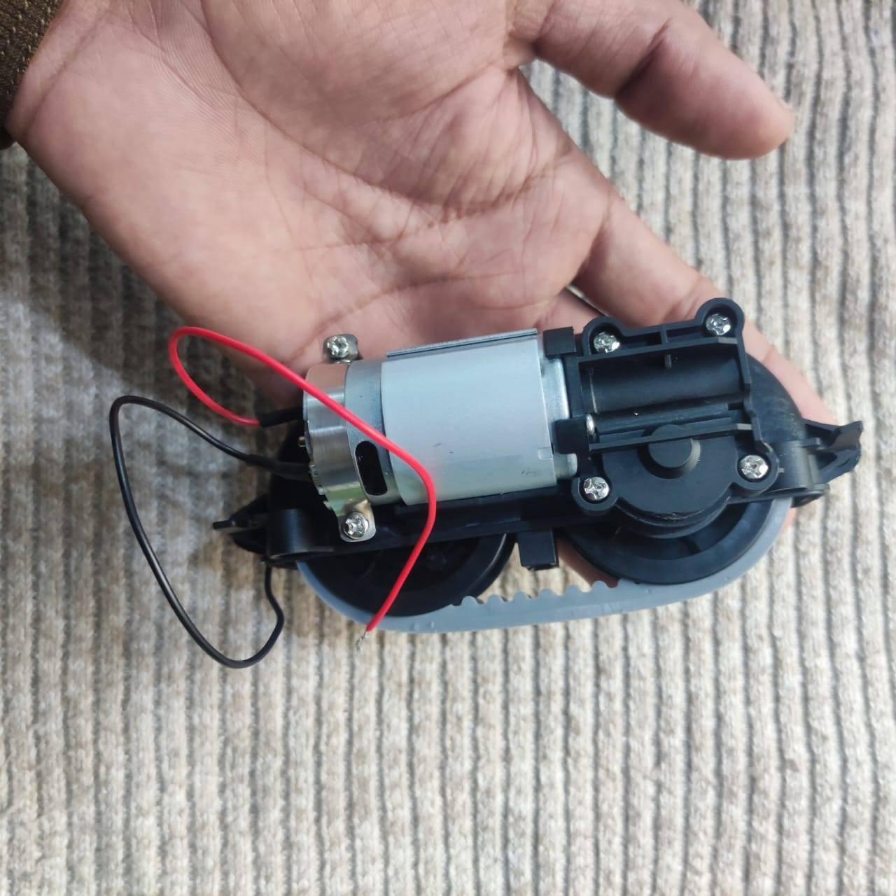 DC Gear Motor With 3.7V To 12V Operated - a silver cylindrical motor attached to a black plastic gearbox with a grey rubber drive belt.