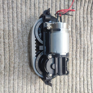 DC Gear Motor With 3.7V To 12V Operated - a silver DC motor attached to a black plastic gear assembly with a grey toothed belt and red/black wires.
