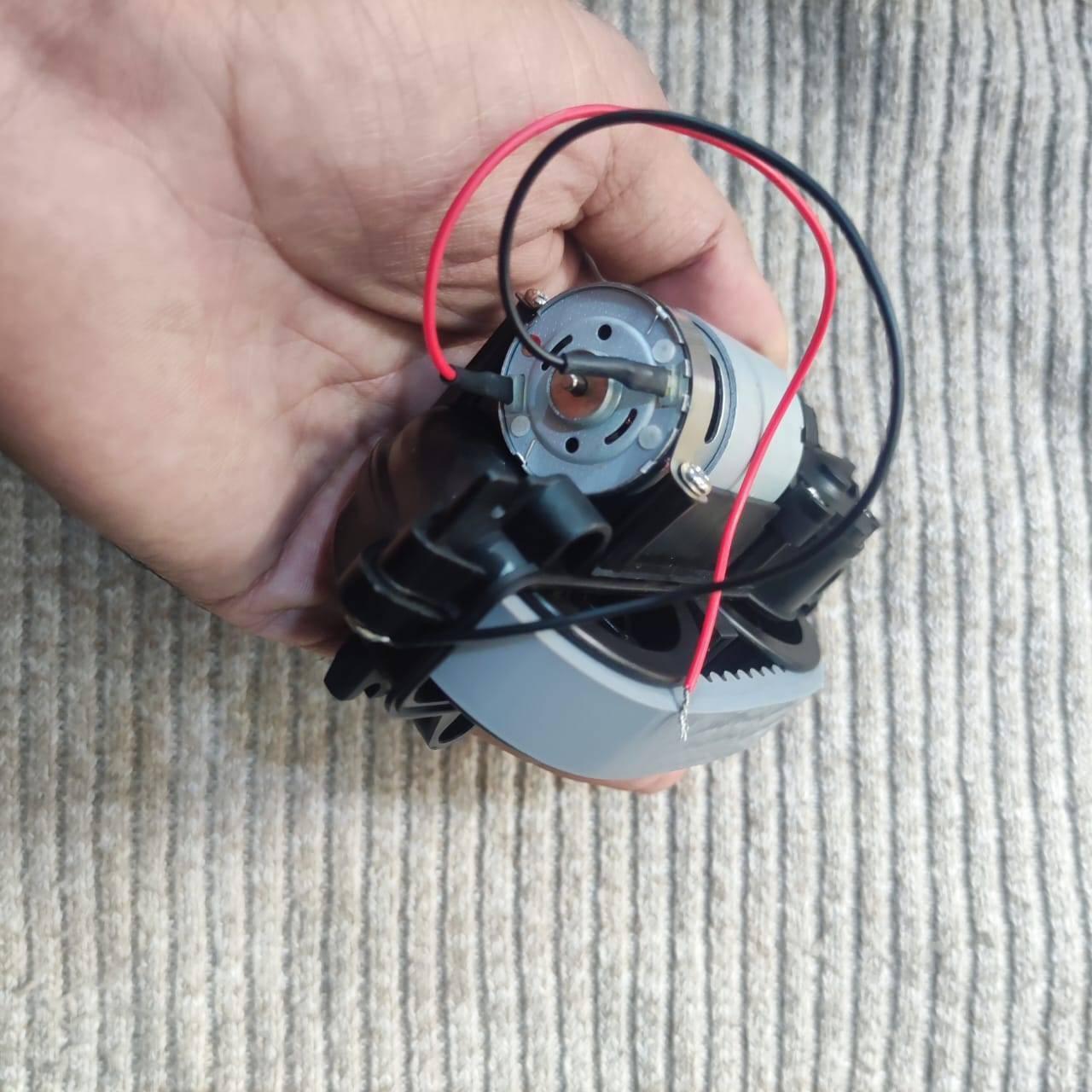 DC Gear Motor With 3.7V To 12V Operated - shown as a close-up of the silver motor housing with red and black wires connected to the terminals.