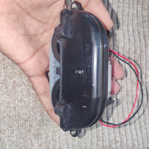 DC Gear Motor With 3.7V To 12V Operated - a black plastic gear assembly held in a hand with two attached red and black power wires.