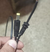 DC Male Power Connector DC Jack With 1 Meter Wire - a close-up of a black DC barrel plug and a cut wire end with exposed copper strands.
