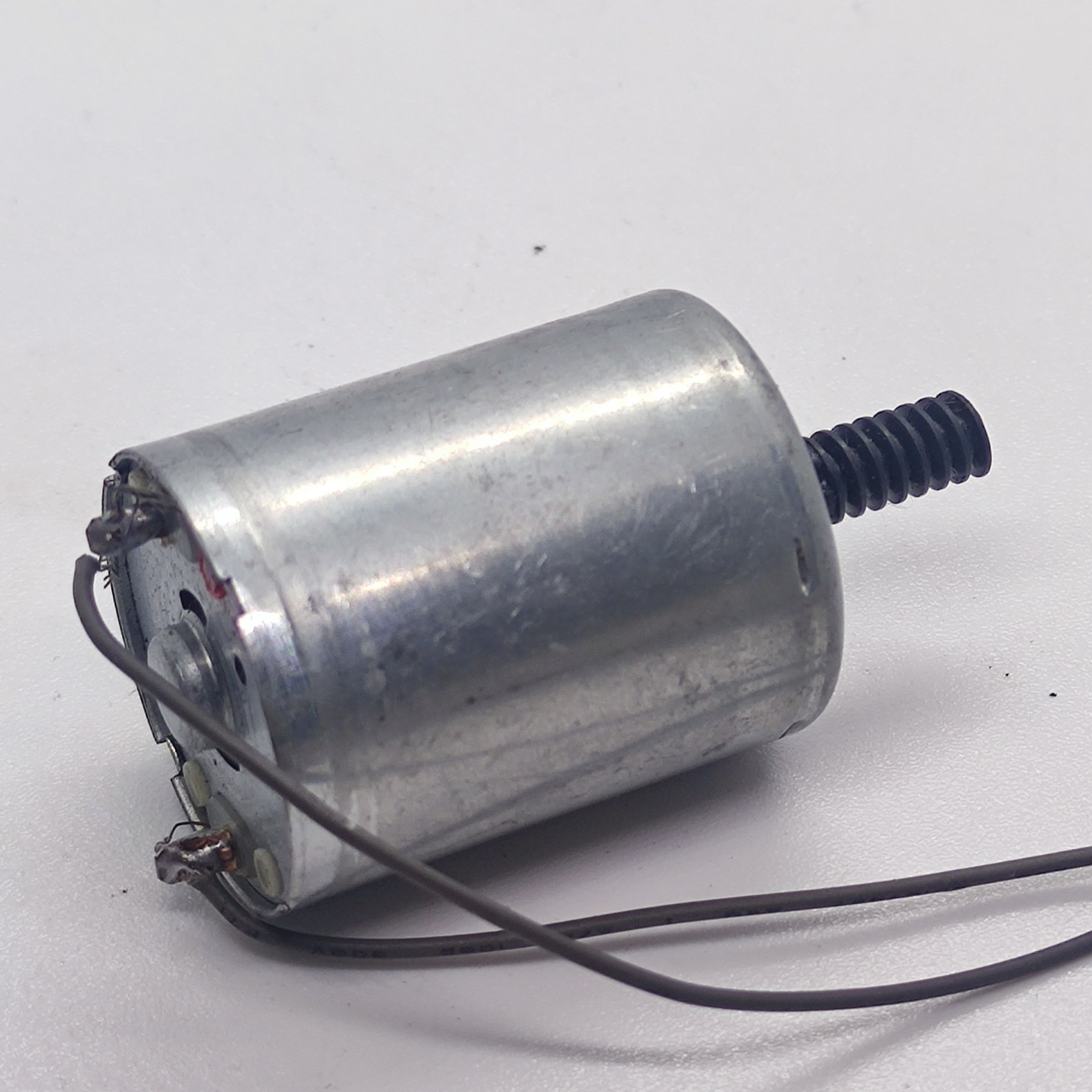 DC Motor 2V To 24V 5100RPM - a silver cylindrical motor with a black worm gear on the shaft and two attached wires connected to the rear terminals.