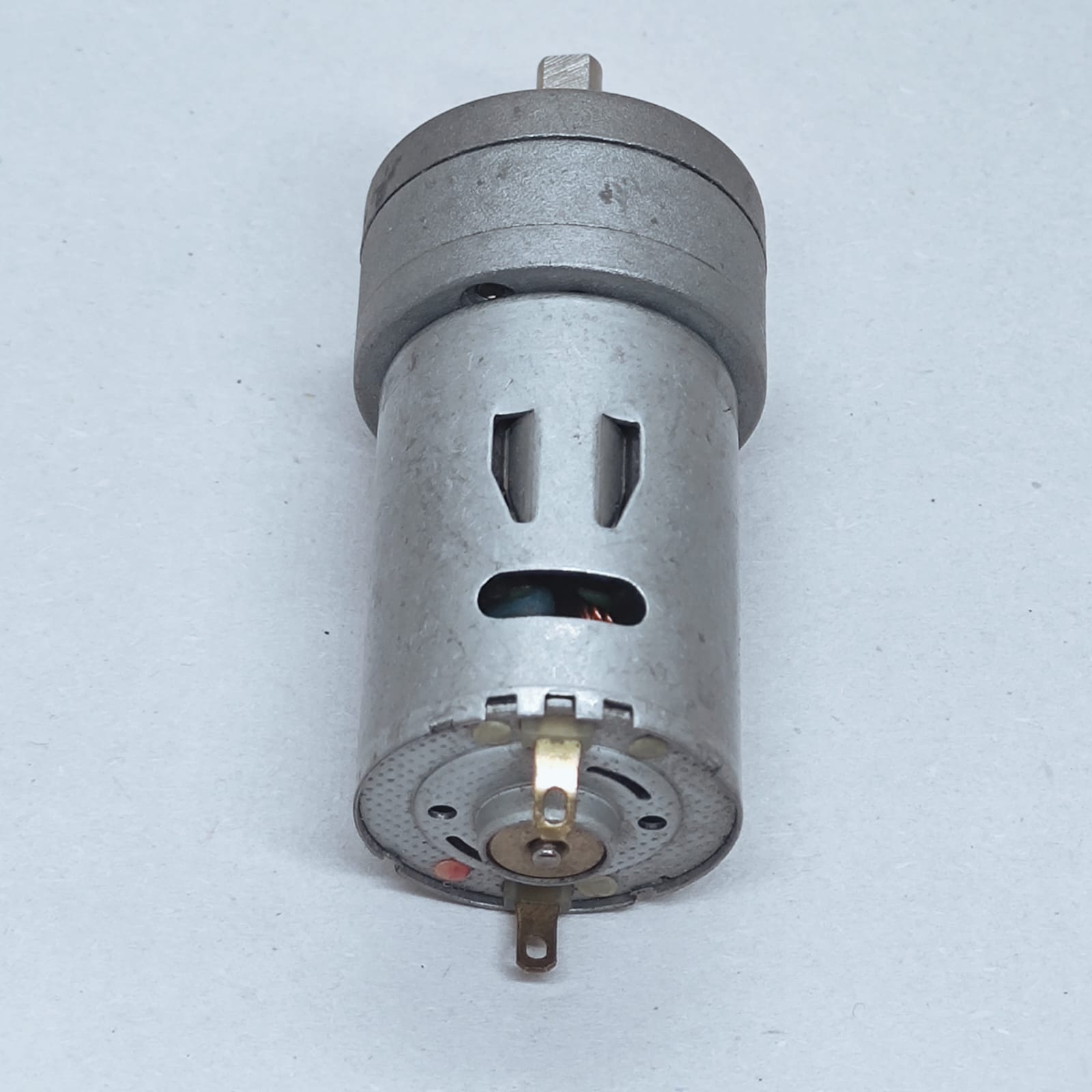 DC Motor DC Electric Geared Motor - shown as a silver cylindrical motor with a gear box at the top and two metal electrical terminals at the base.