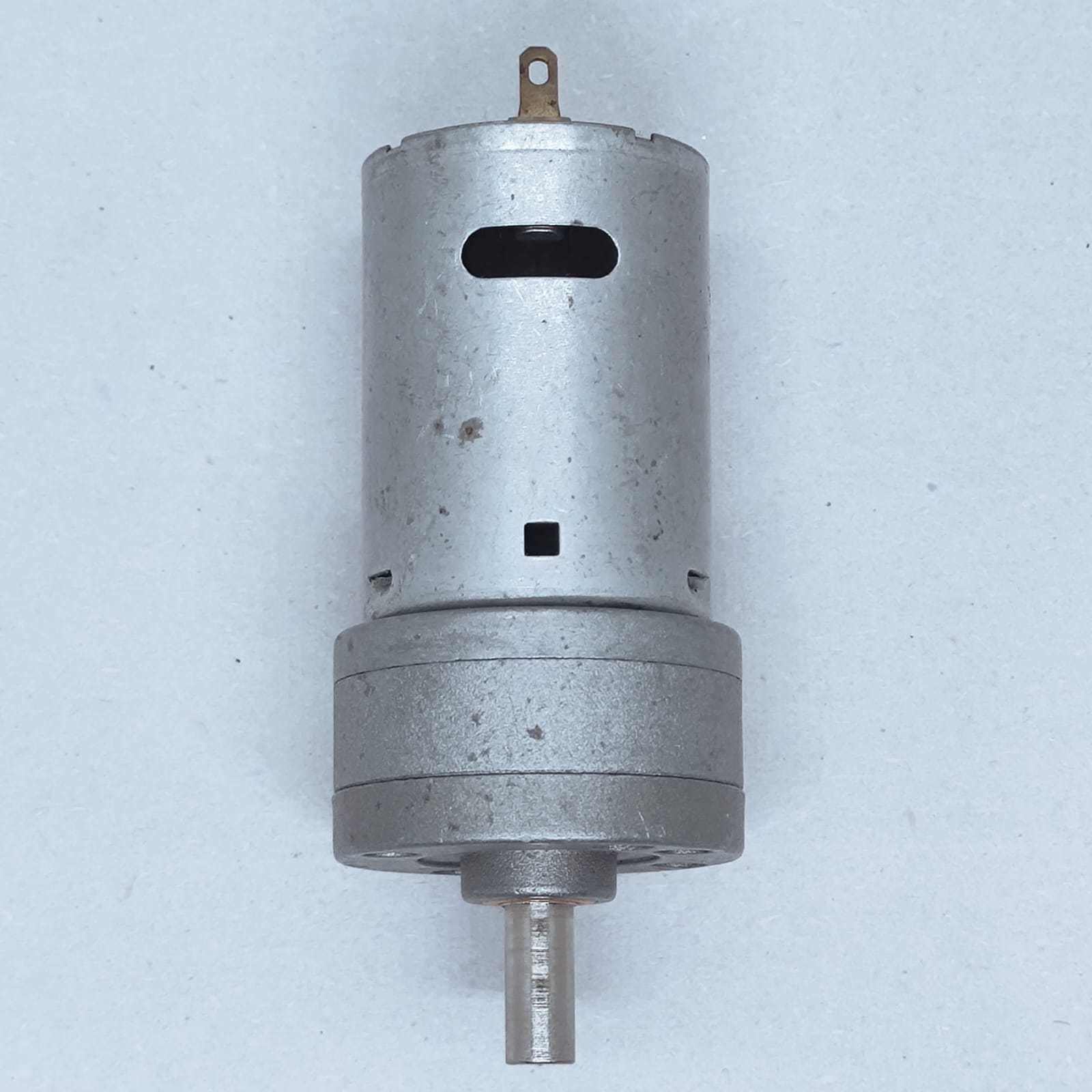 DC Motor DC Electric Geared Motor - shown as a silver cylindrical motor with an attached gearbox and a single metal output shaft.