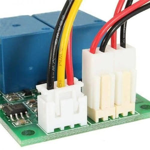 DC Motor Speed And Direction Controller Board - a close-up of the green circuit board, blue relays, and three white wire harness connectors.