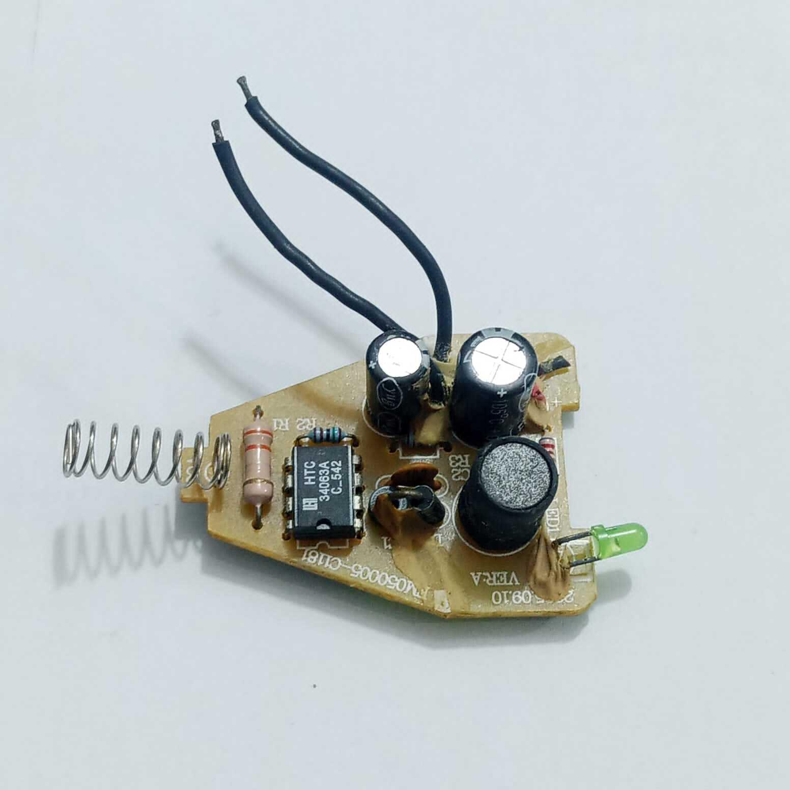 DC To DC Convertor IC 34063A - mounted on a small brown circuit board with a spring, two capacitors, a black cylinder, a green LED, and two black wires.
