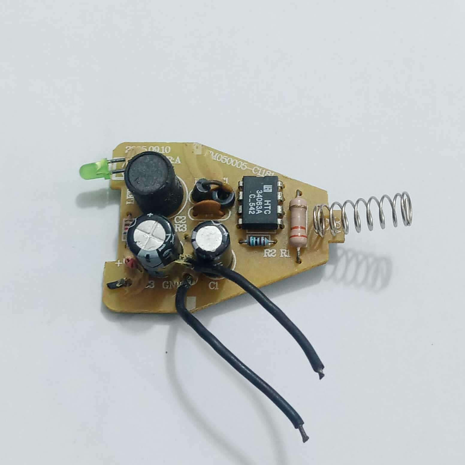DC To DC Convertor IC 34063A - a green LED, two electrolytic capacitors, a resistor, and a metal spring antenna.