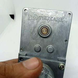 DC Worm Gear Motor AXO40231 - a close-up of the silver metal gearbox housing featuring the Tsukasa logo and a central output shaft.