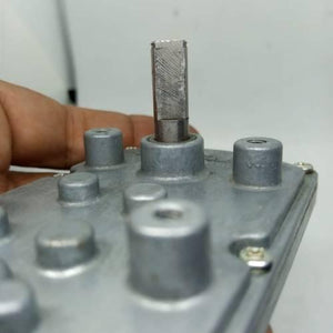 DC Worm Gear Motor AXO40231 - close-up view of the silver metallic gear housing and the protruding rectangular-shaped output shaft.