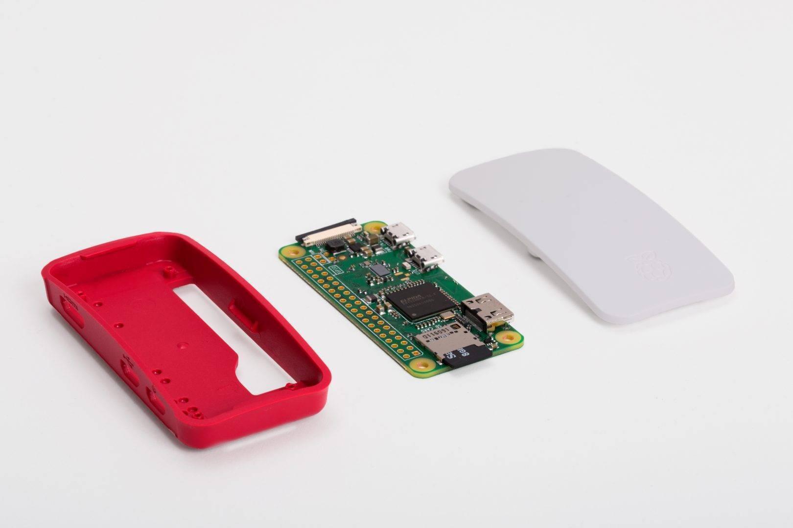 Dell Raspberry Pi Zero Official Case With GPIO And Camera Hole For Raspberry Pi Zero w - a red base, a white lid, and a Raspberry Pi Zero circuit board with a micro SD card inserted, laid out separately.
