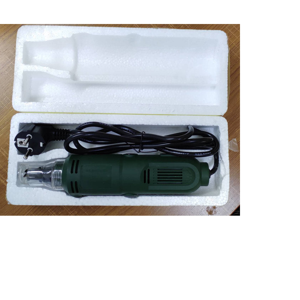 Df-8 Enameled Wire Stripping Machine, Varnished Wire Stripper, Enameled Copper-digilog.pk - shown in its open white styrofoam packaging, featuring a green handheld tool with a power cord and plug.