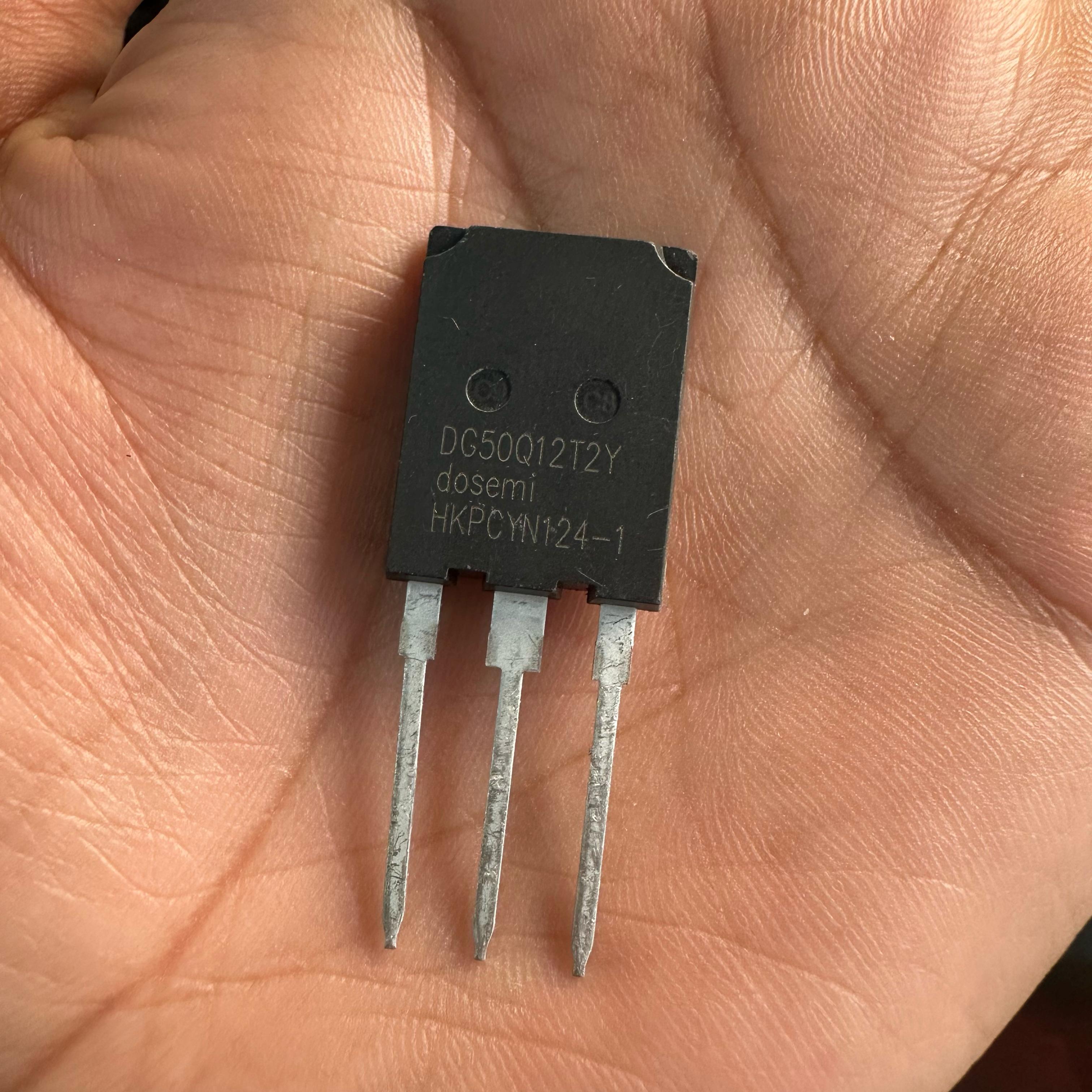 DG50Q12T2 50amp 1200V Dosemi | High-power IGBT Module | Digilog.pk - a black three-pin electronic component held in a palm with the model number printed on its face.