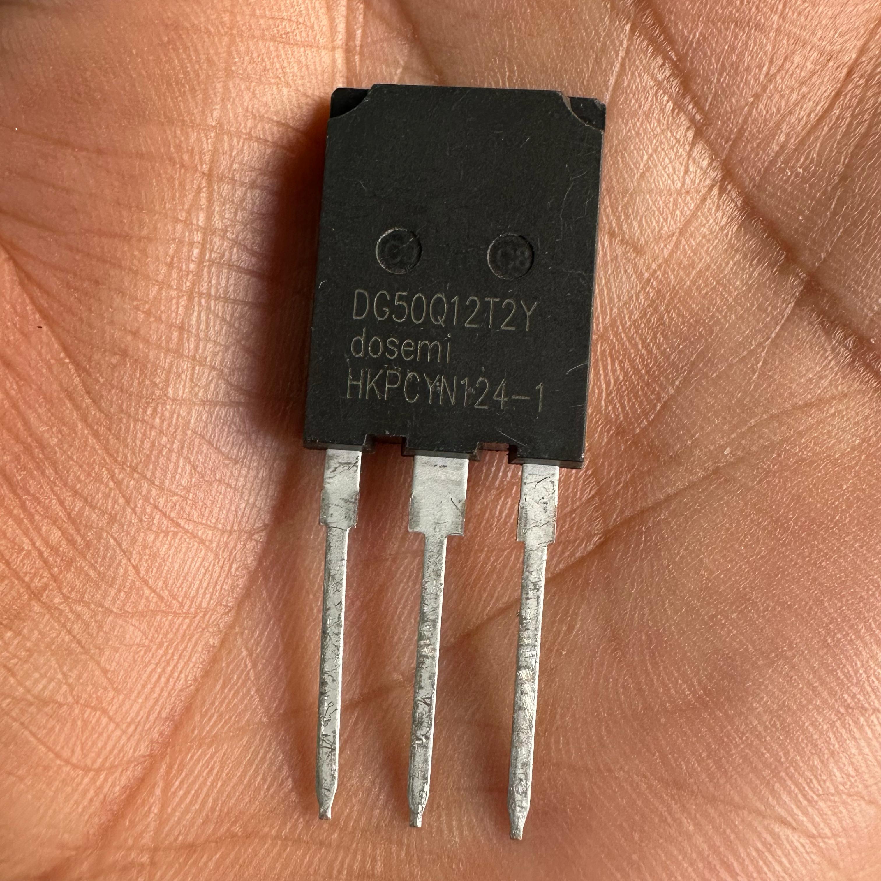 DG50Q12T2 50amp 1200V Dosemi | High-power IGBT Module | Digilog.pk - a black rectangular electronic component with three metal pins, held in a palm.