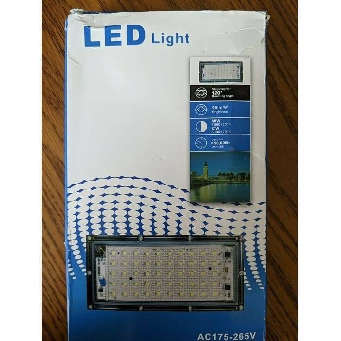 Different Colors Portable Energy Saving Outdoor RGB LED Lights Lamp Floodlight With Remote AC175-265V - shown in its original white and blue cardboard packaging box with printed technical specifications.