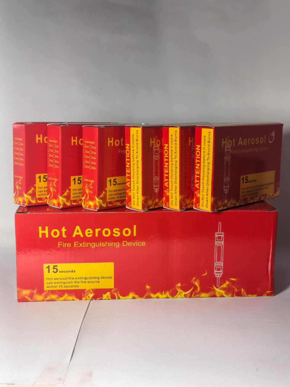 DIGILOG QRR0.01G Heat Aerosol Fire Extinguishing Device - shown as a large red box with six smaller red individual product boxes stacked on top.