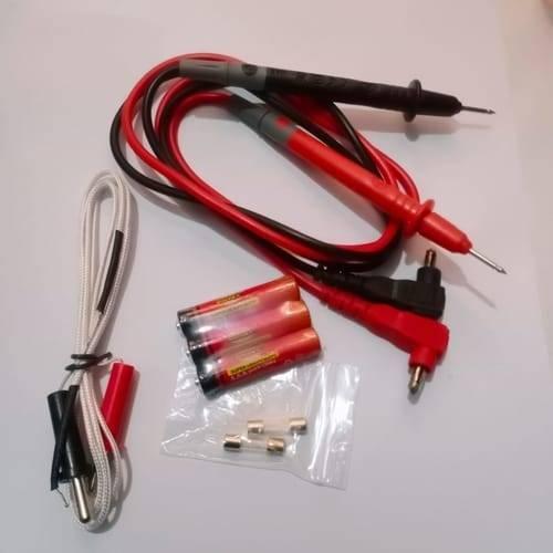 Digital Display Multimeter Ut 31 Non Contact Voltmeter Ammeter Ohm Temperature Test Meter DMM - accessories including red and black test leads, three AAA batteries, a temperature probe, and two small glass fuses.