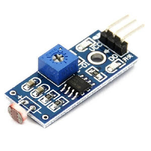 Digital LDR Sensor Module - a blue circuit board with a light-dependent resistor, a potentiometer, an LM393 chip, and a three-pin header.