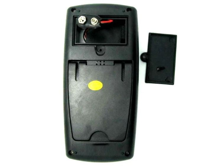 Digital Multimeter - DT-9205B - rear view showing the open battery compartment with a 9V battery connector and the detached black plastic battery cover.