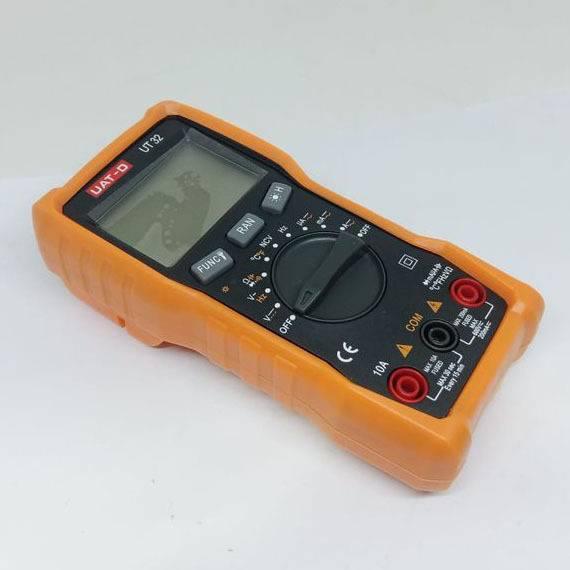 Digital Multimeter Uat-d Ut 32 - an orange handheld device featuring a central rotary dial, function buttons, a digital display, and three input ports.