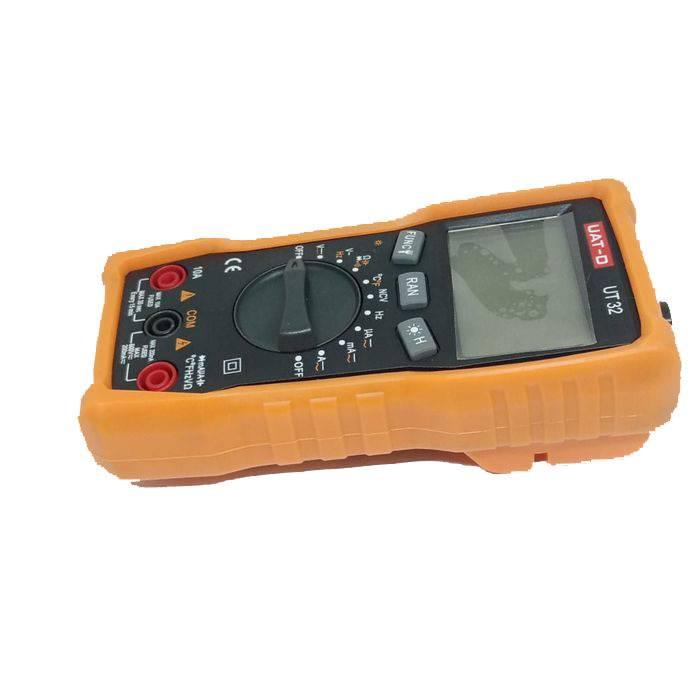 Digital Multimeter Uat-d Ut 32 - shown at an angle, featuring an orange protective case, a rotary dial, function buttons, and an empty LCD screen.
