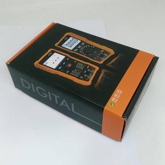 Digital Multimeter Uat-d Ut 32 - shown inside its black and orange retail packaging box, which features printed illustrations of the device.