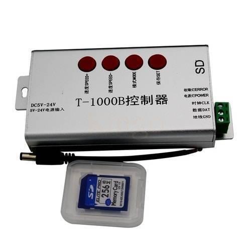 Discontinued Addressable LED Pixel Controller T1000B T-1000B - silver rectangular case with four red buttons, a green terminal block, a power cable, and a 256MB SD card in a plastic case.