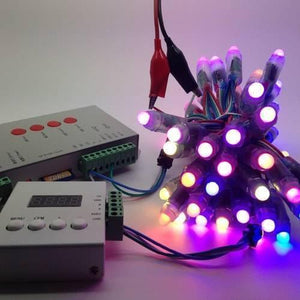 Discontinued Addressable LED Pixel Controller T1000B T-1000B - connected to a bundle of glowing multi-coloured LED pixels and a small control box with a digital display.