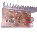 Discontinued Audio Amplifier Board - a brown circuit board with a silver heat sink, two large orange capacitors, and various electronic components.