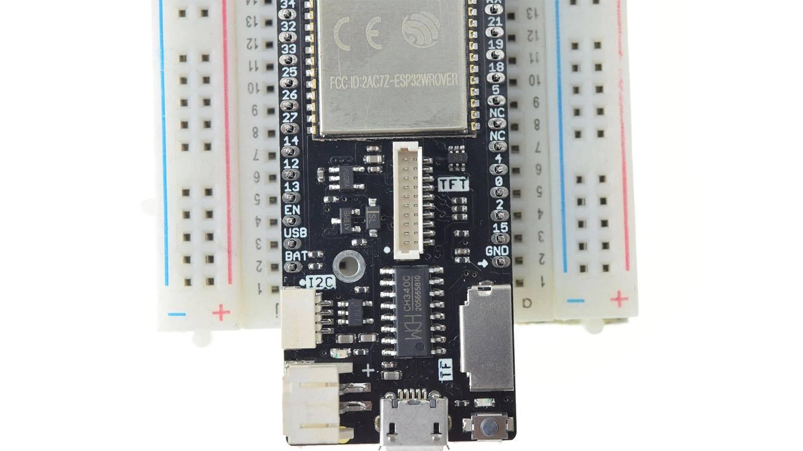 Discontinued Lolin D32 Pro V2.0.0 - WiFi & Bluetooth Board Based ESP-32 ESP32 REV1 ESP32-wrover 16MB 8MB 4MB Flash Psram Micropython - a black ESP32 development board with a metal shield, mounted on a white breadboard, featuring a micro-USB port and connectors.