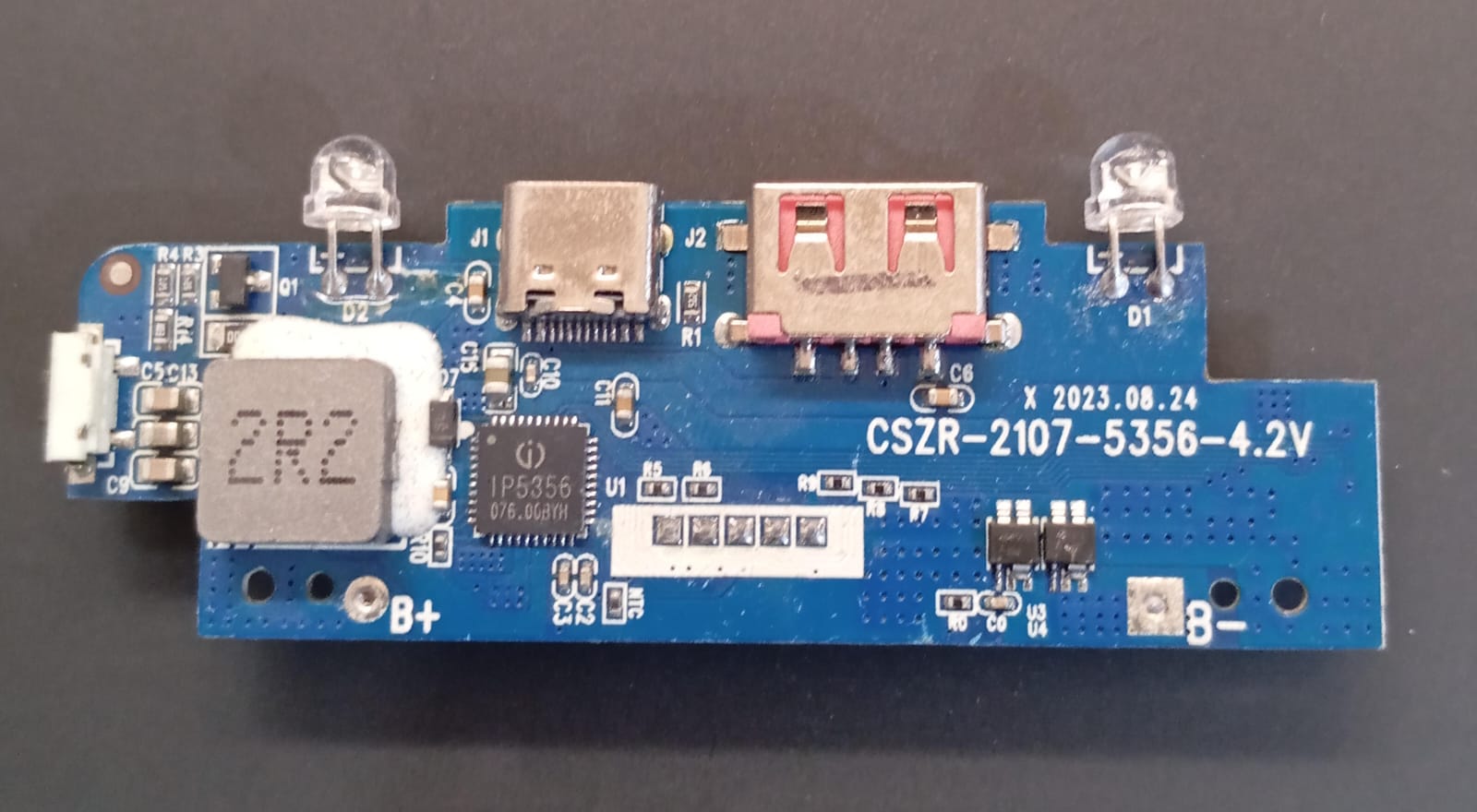 Power Bank Charging Module Board – CSZR-2107A-5356 (4.35V) ( stock LOT ) - a blue rectangular circuit board featuring a USB port, a USB-C port, two LEDs, and an inductor.