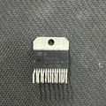 Discontinued TDA7294 100W Audio Power Amplifier IC - TO-220-15 Package - a black rectangular electronic component with fifteen metal pins and a top mounting hole, shown close-up.
