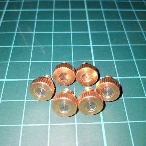 Disinfection Gate Misting System Accessory With Brass Nozzle - six circular, gold-toned brass misting nozzles arranged on a green cutting mat.