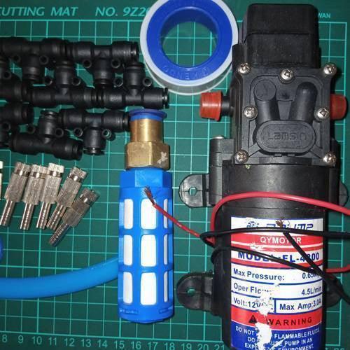 Disinfection Gate Misting System Accessory With Steel Nozzle - a 12V pump, blue filter, black T-connectors, metal nozzles, and white tape.