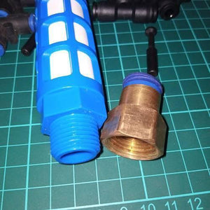 Disinfection Gate Misting System Accessory With Steel Nozzle - shown as a close-up of a blue plastic filter component and a brass threaded connector.