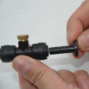 Disinfection Mist Making Nozzle And t Base Fogging Sanitization - a hand inserting a black plastic plug into the nozzle's T-shaped base connector.