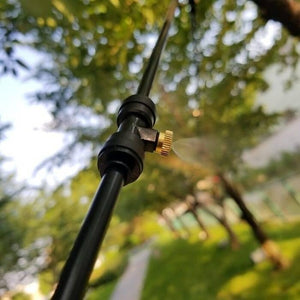 Disinfection Mist Making Nozzle And t Base Fogging Sanitization - close-up of a black plastic T-connector with a brass misting nozzle spraying water.