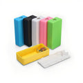 DIY 18650 Power Bank Case 2xCell - shown as five assembled units in blue, black, white, pink, and green, with one yellow disassembled case and a white lid.