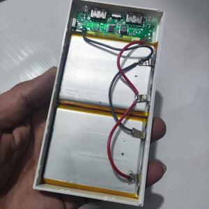 DIY 5V 2A Dual USB Power Bank Case With Power Bank Kit - an open white plastic casing with two battery cells connected to a circuit board.