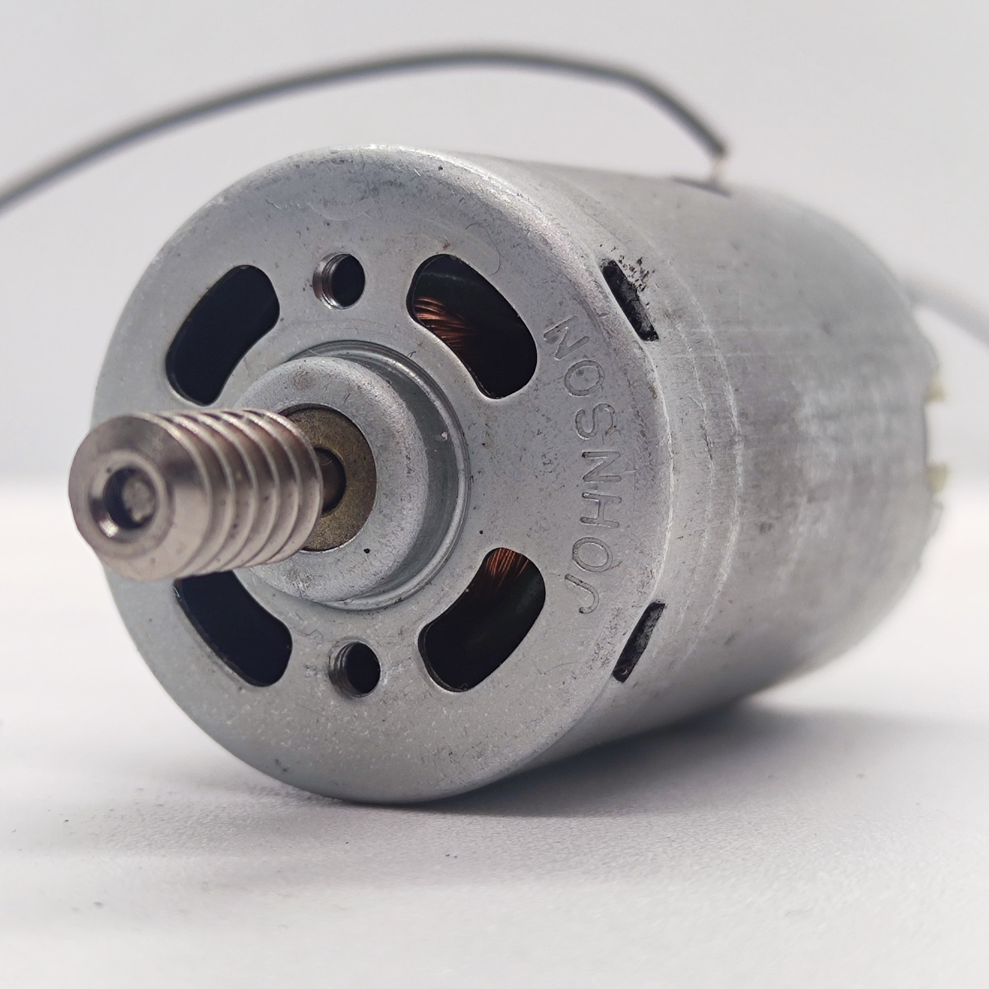 DIY DC Motor DC 3V To 25V Torque Mini Motor 17500RPM - a silver cylindrical DC motor with a threaded metal shaft and the brand name Johnson.