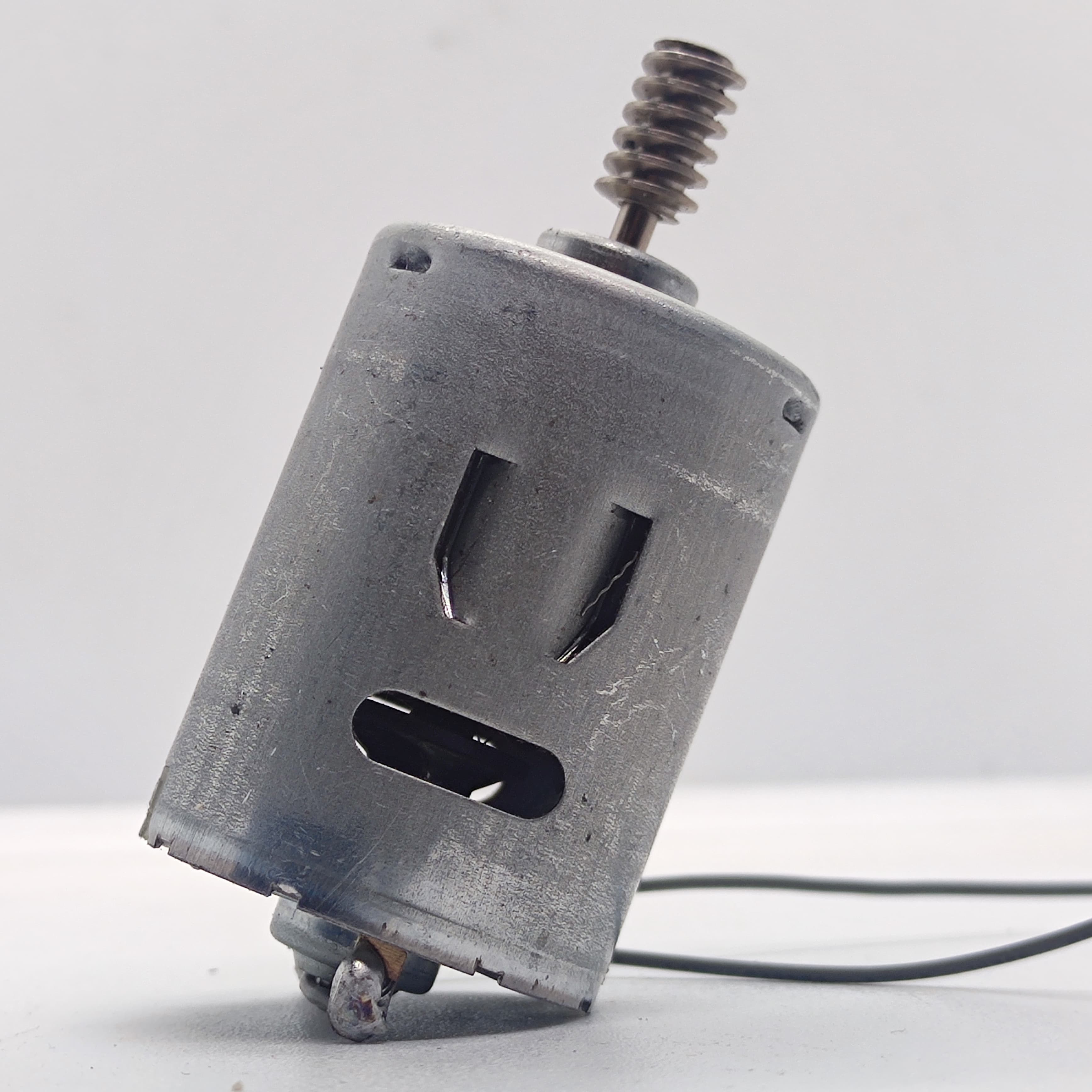 DIY DC Motor DC 3V To 25V Torque Mini Motor 17500RPM - a silver cylindrical motor with a threaded metal shaft and two thin black wires attached.