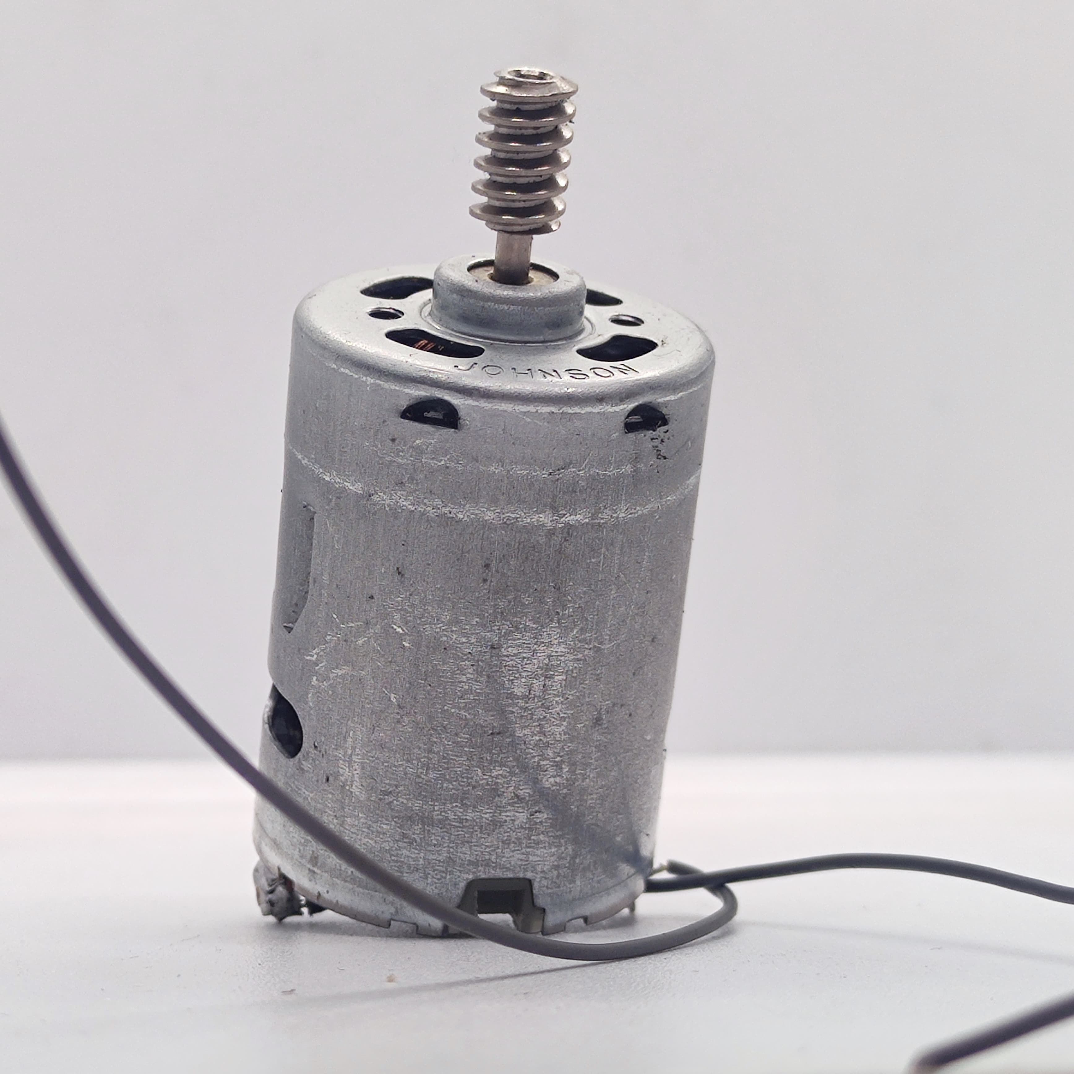 DIY DC Motor DC 3V To 25V Torque Mini Motor 17500RPM - a silver cylindrical motor with a metal worm gear on the shaft and two attached black wires.