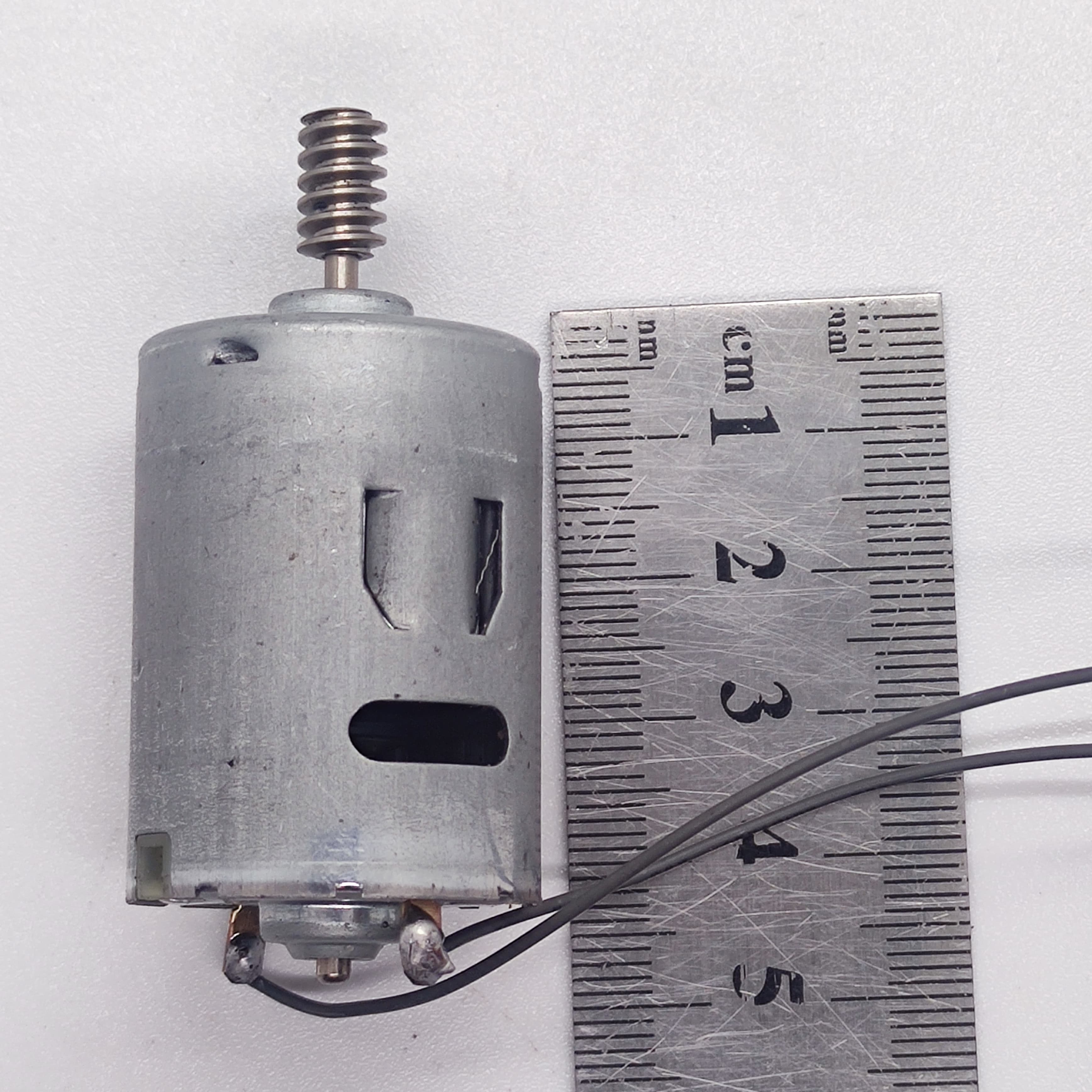 DIY DC Motor DC 3V To 25V Torque Mini Motor 17500RPM - shown as a silver cylindrical motor with a worm gear shaft, two wires, and a metal ruler for scale.