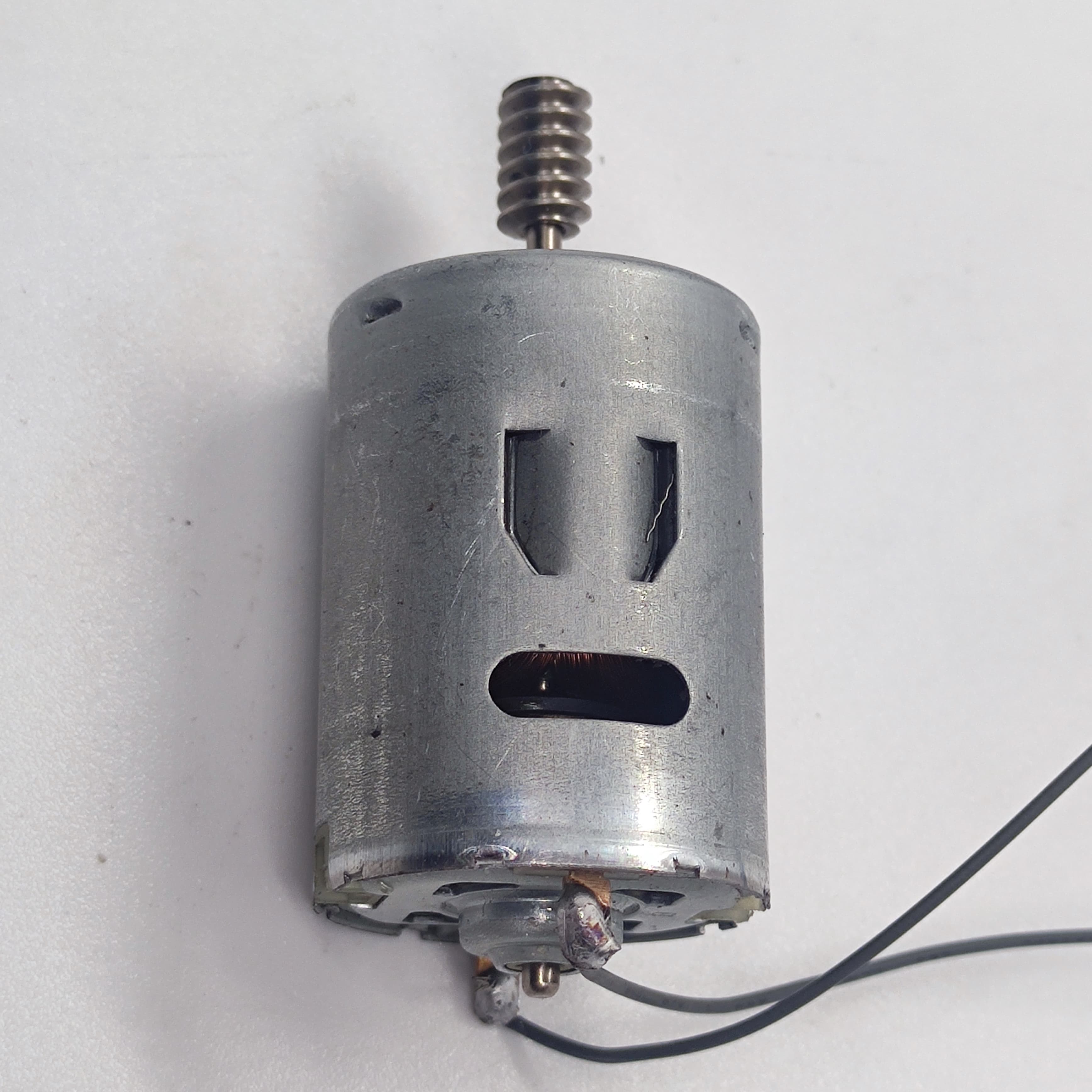 DIY DC Motor DC 3V To 25V Torque Mini Motor 17500RPM - a silver cylindrical DC motor with a metal worm gear on the shaft and two black wires.