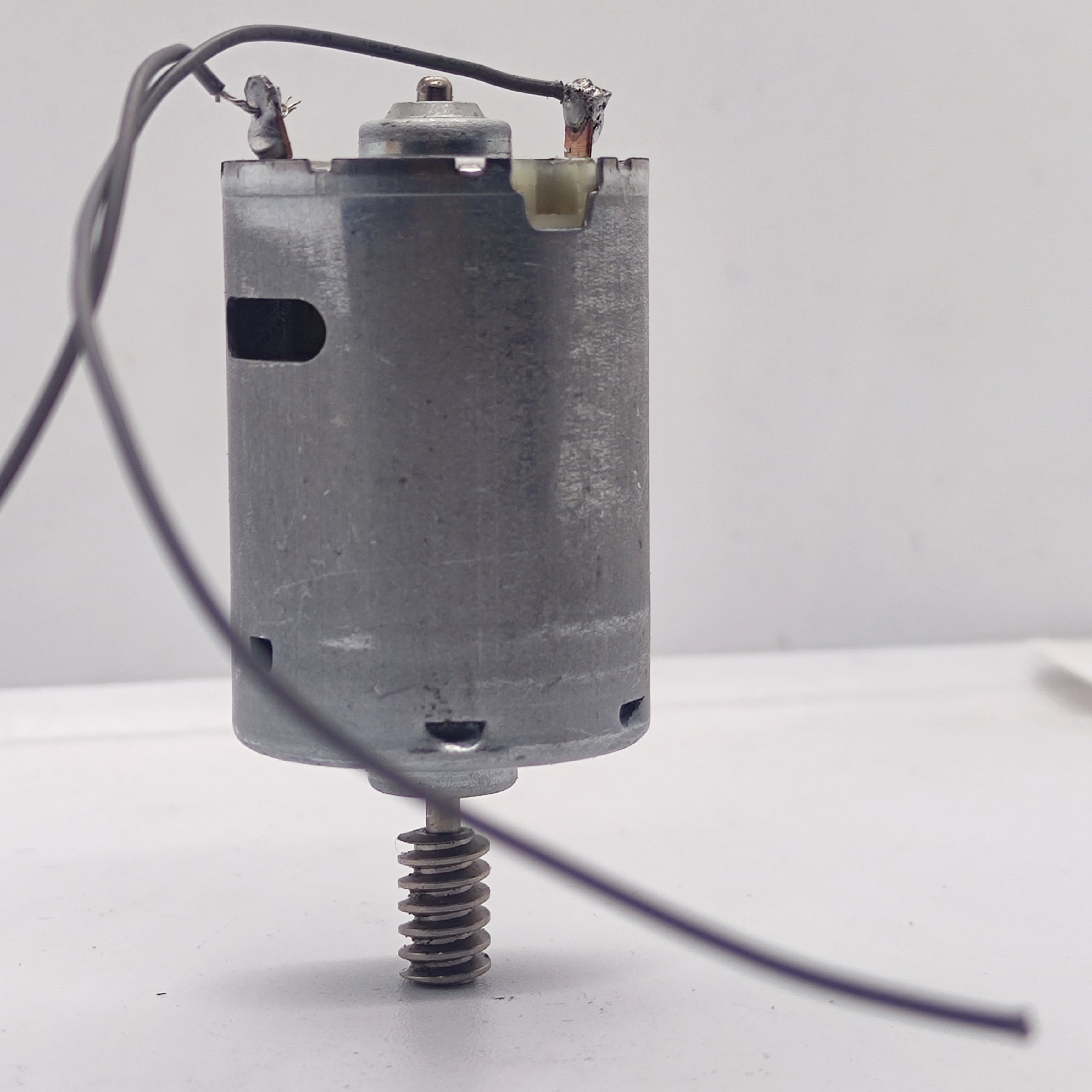 DIY DC Motor DC 3V To 25V Torque Mini Motor 17500RPM - a silver cylindrical motor with a worm gear on the shaft and two soldered wires at the top.