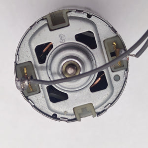DIY DC Motor DC 3V To 25V Torque Mini Motor 17500RPM - a close-up view of the silver circular back end showing two metal terminals with a wire attached.