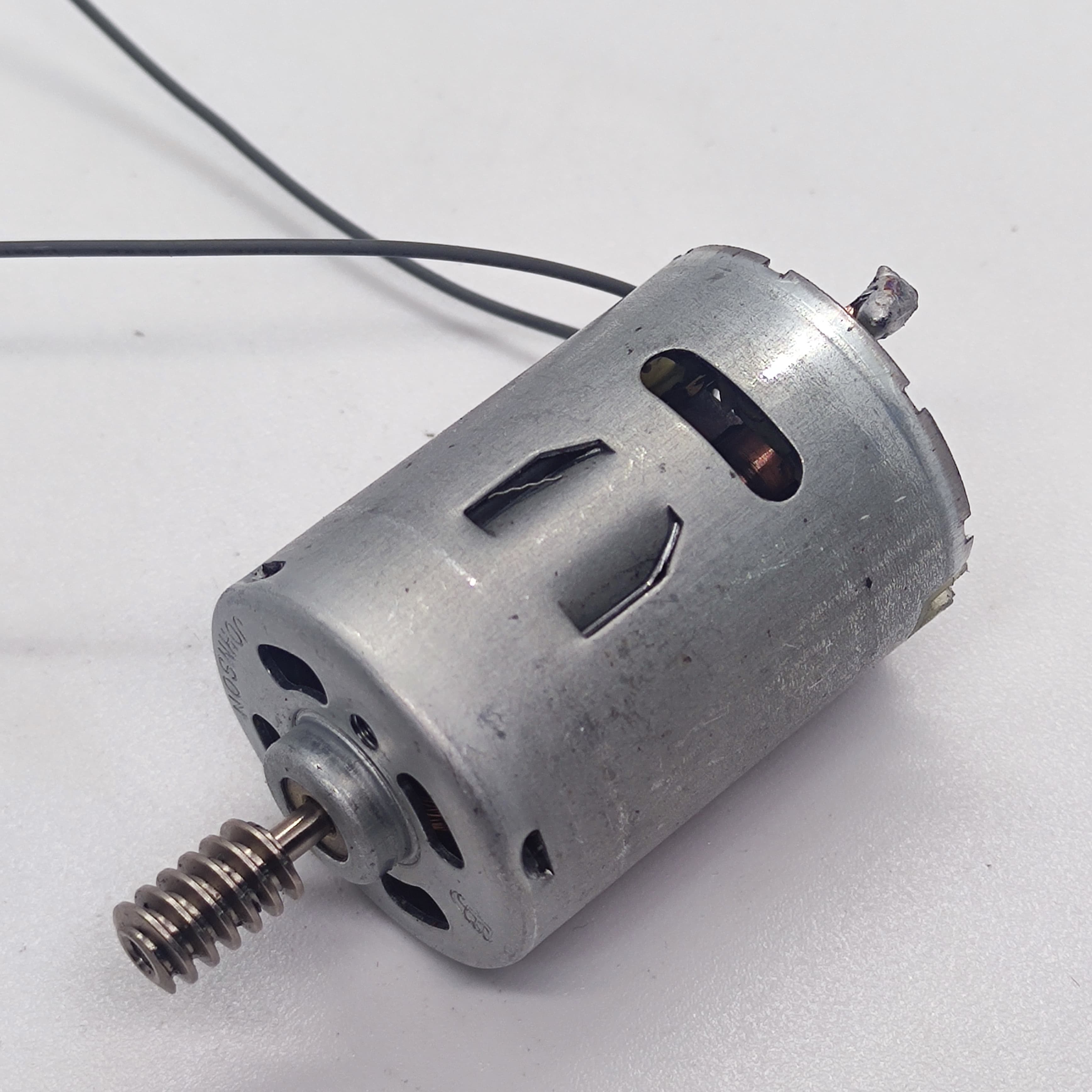 DIY DC Motor DC 3V To 25V Torque Mini Motor 17500RPM - a silver cylindrical motor with a worm gear on the shaft and two attached black wires.